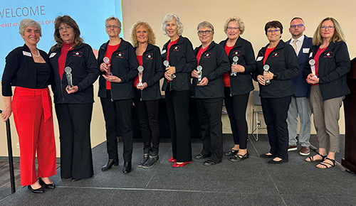 Hall of Fame recipients holding awards