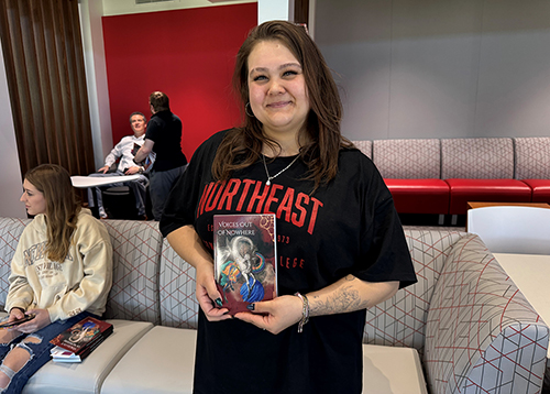 Aliyah Rodriguez holding a book title voices out of nowhere