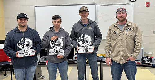 welding students holding awards