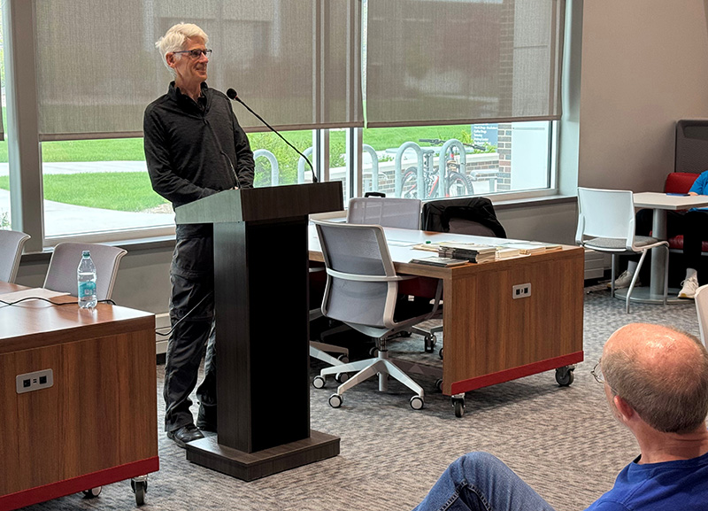 Jim Daniels speaking at podium