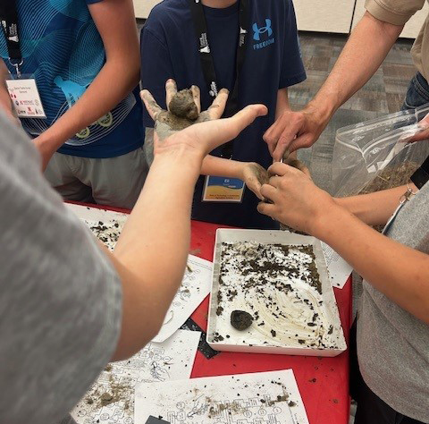 students learning about agriculture, holding soil