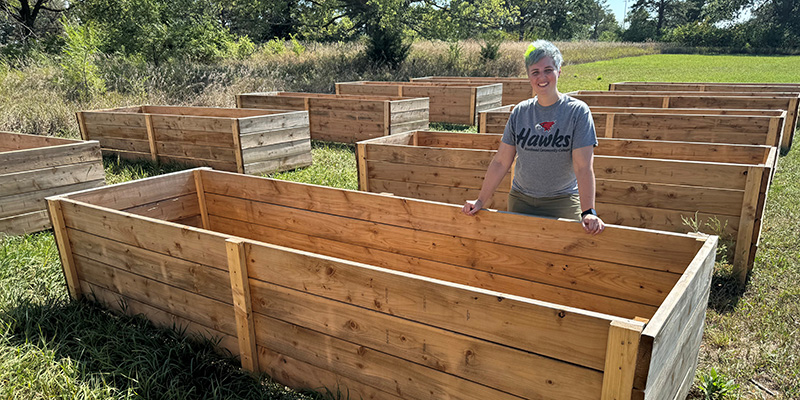 Instructor shows raised beds where produce can be grown