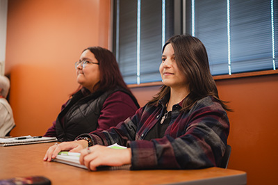 2 students sitting at a desk in a classroom