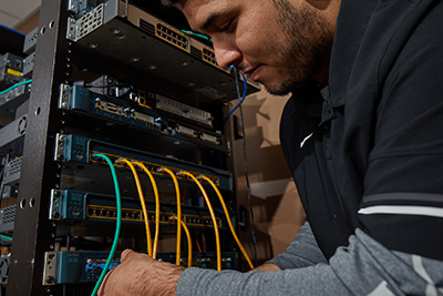 Student working on equipment during IT lab. 