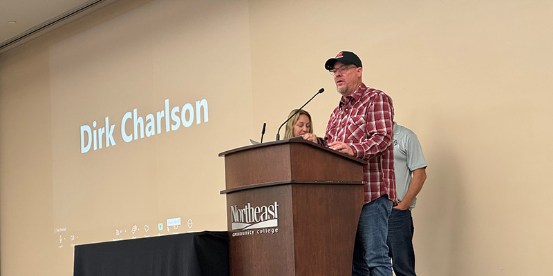 Dirk Charlson speaking at podium